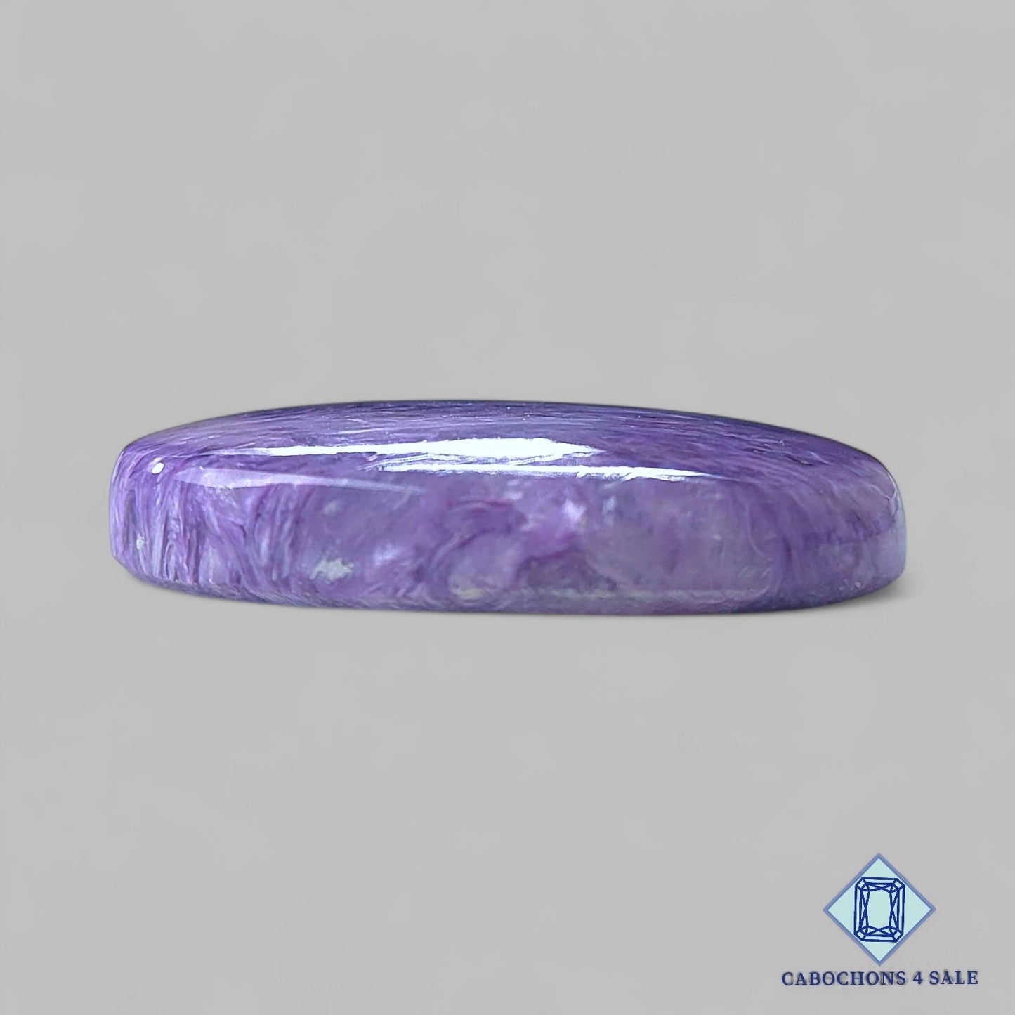 Cabujones ovalados de piedra preciosa de charoita natural de 34 x 23 x 7 mm, procedentes de Rusia, disponibles para la venta.