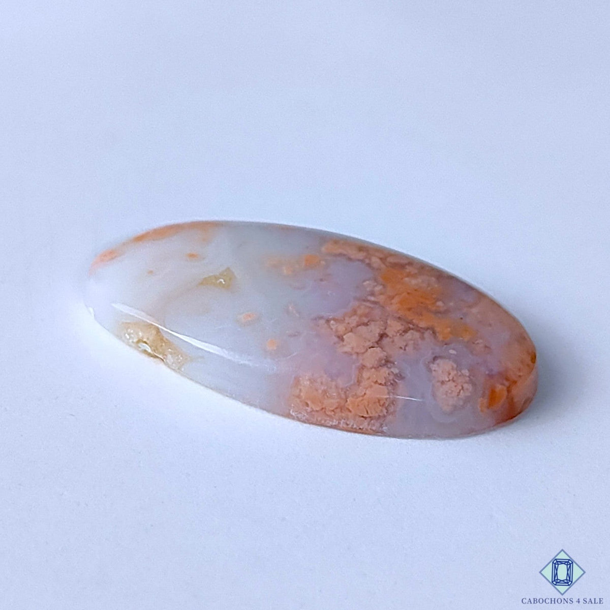 Cabochons4sale oval cotton candy agate cabochon with opaque orange and white patterns, 31x18x5mm gemstone.