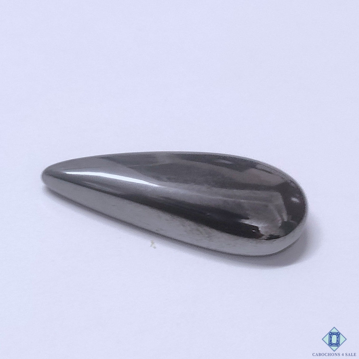 Cabochons4sale grey gun metal pear cabochon gemstone with a smooth opaque finish, 31x12x6mm size.