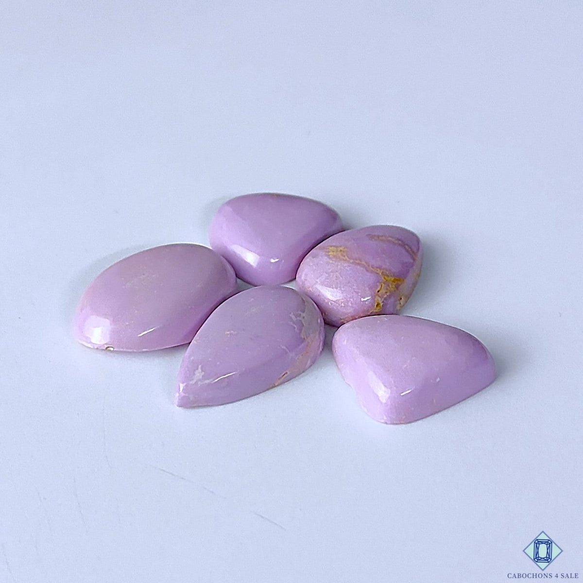 Cabochons4sale purple phosphosiderite gemstone lot in various mixed shapes with opaque finish on white background