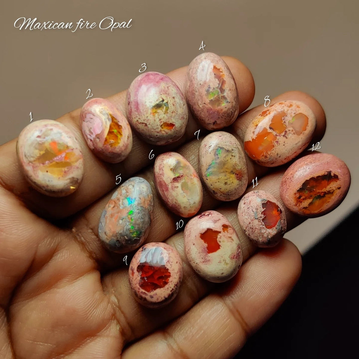 Cabochons4sale collection of natural Mexican fire opal gemstones in various orange and pink hues held in a hand