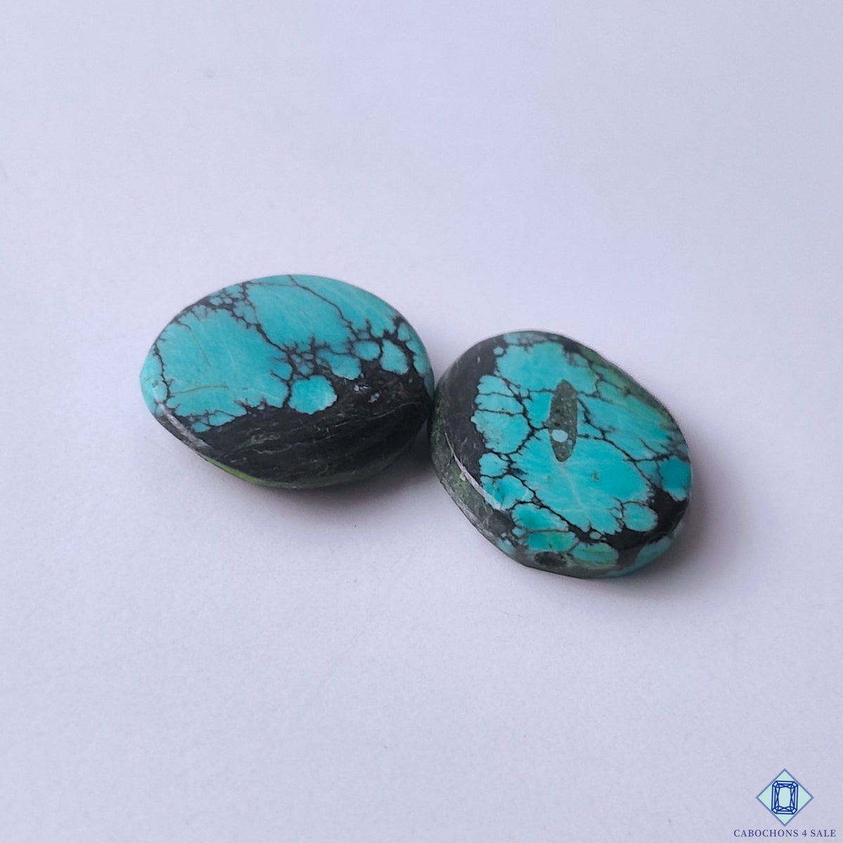 cabochons4sale, blue turquoise oval cabochons featuring rich gemstone color, natural matrix details and artisan-quality polish held between fingers