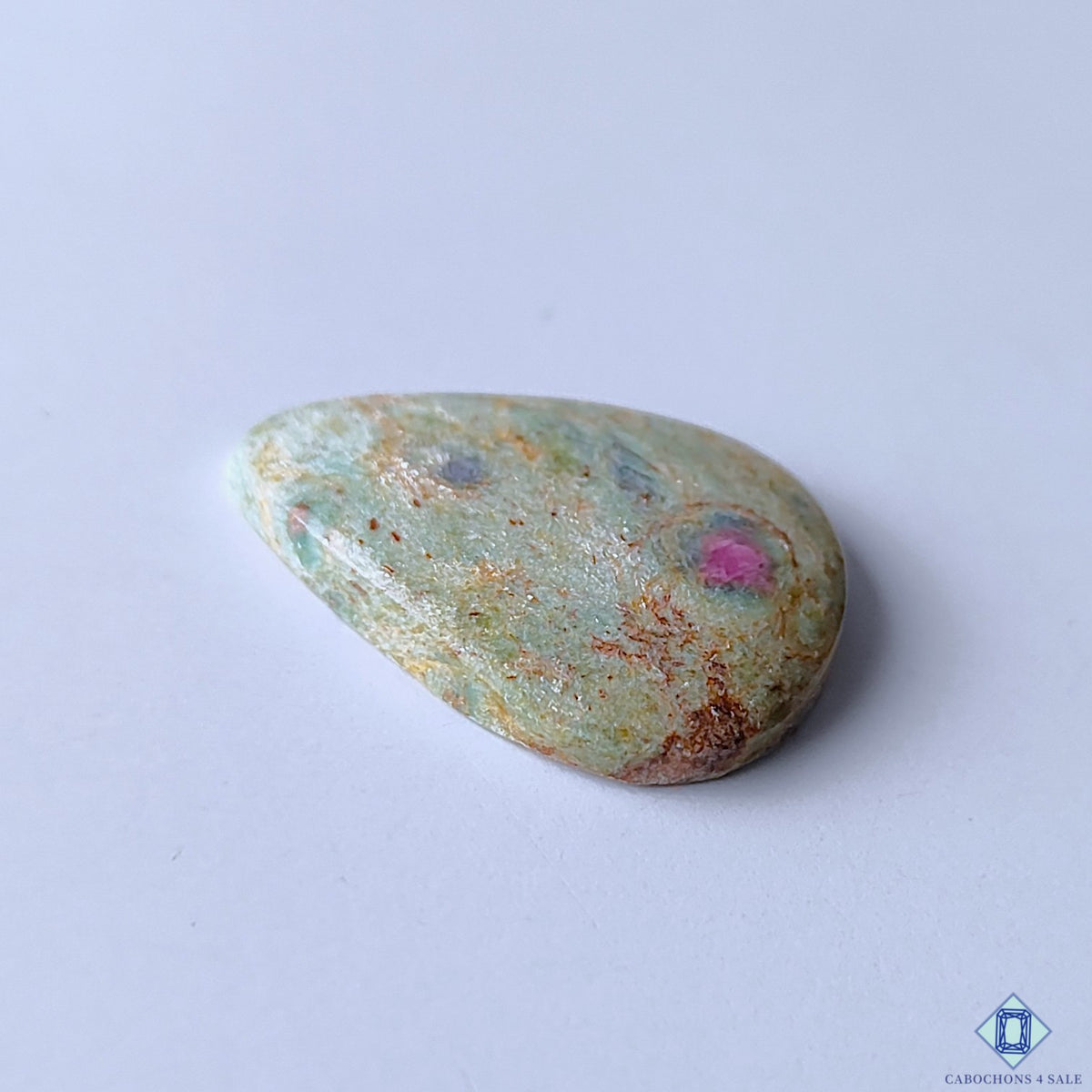 cabochons4sale, natural ruby fuchsite pear cabochons featuring lush green mineral matrix, rosy pink ruby accents and unique organic stone character held between fingers