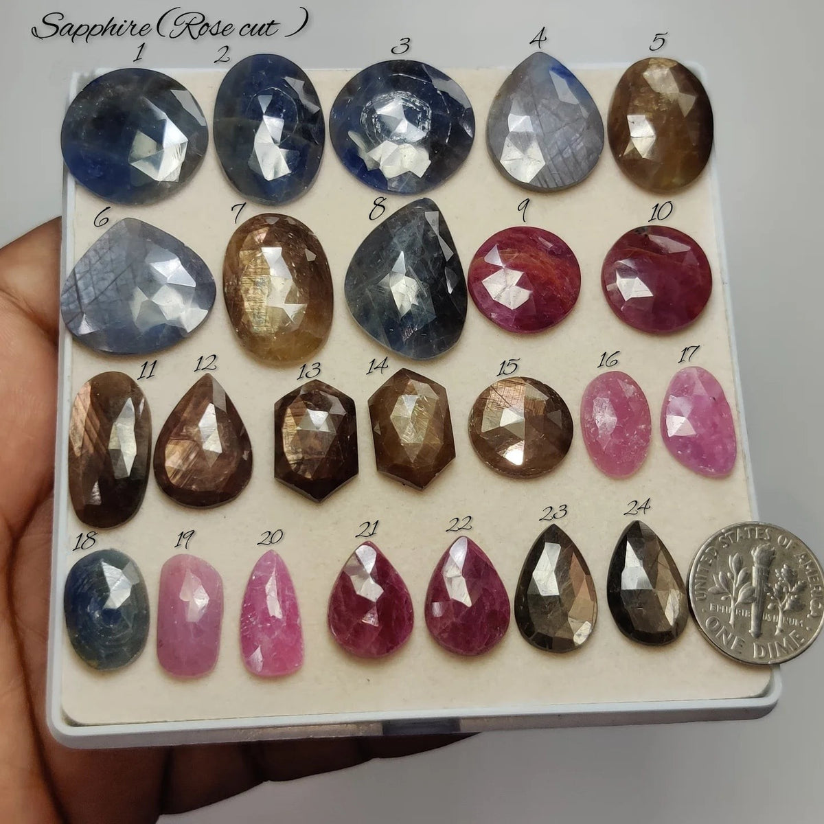 Cabochons4sale collection of natural rose cut sapphire gemstones in various shapes and colours on a display tray.