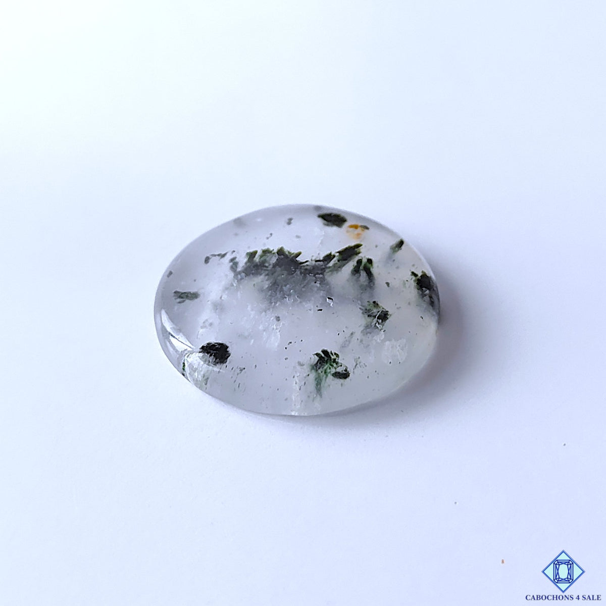 cabochons4sale, polished black dot quartz round cabochons showcasing contrasting black inclusions on white quartz, eye-catching dotted formations and distinctive natural stone character held between fingers