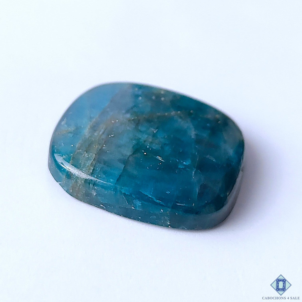 Cabochons4sale blue opaque apatite fancy cabochon gemstone measuring 30x28x6mm with a smooth polished surface.