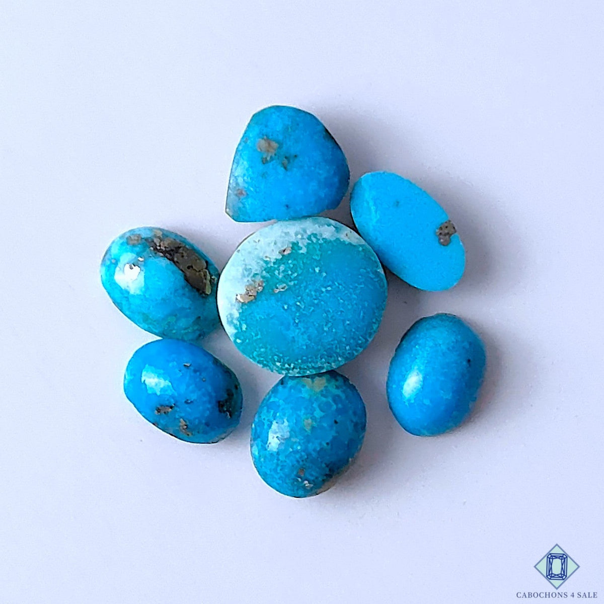 Cabochons4sale natural Arizona turquoise gemstone lot in assorted blue shapes with opaque finish and matrix details.