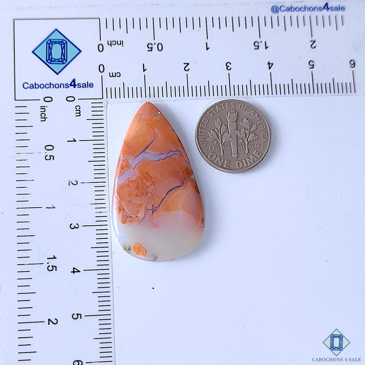Cabochons4sale pear-shaped orange cotton candy agate cabochon with unique banding, shown next to a US dime for scale.