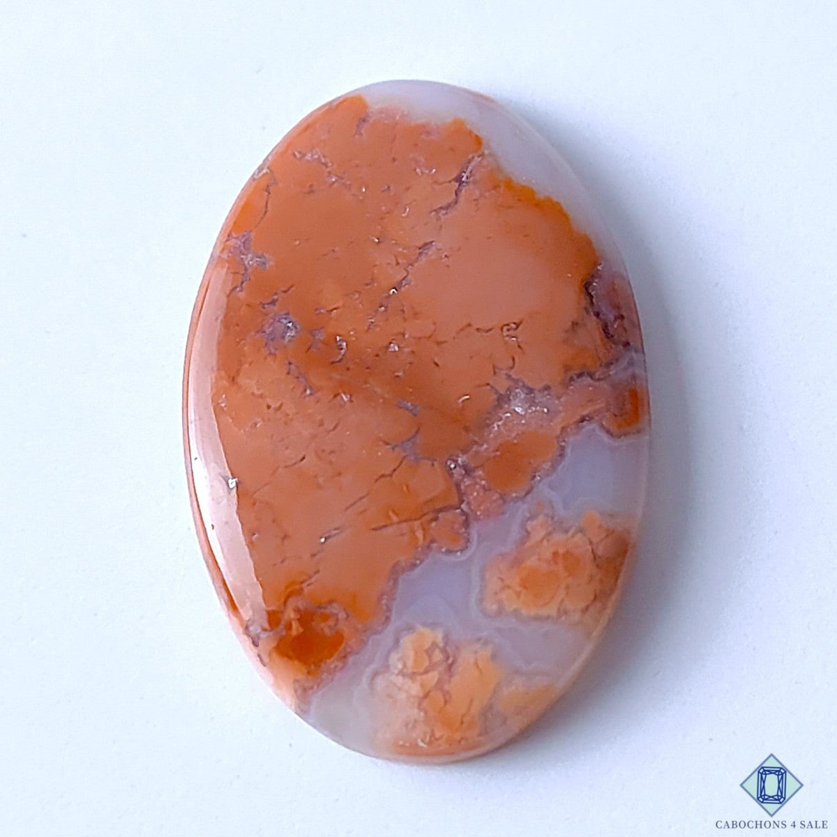 Cabochons4sale oval cotton candy agate cabochon with orange and white opaque patterns measuring 35x23x5mm