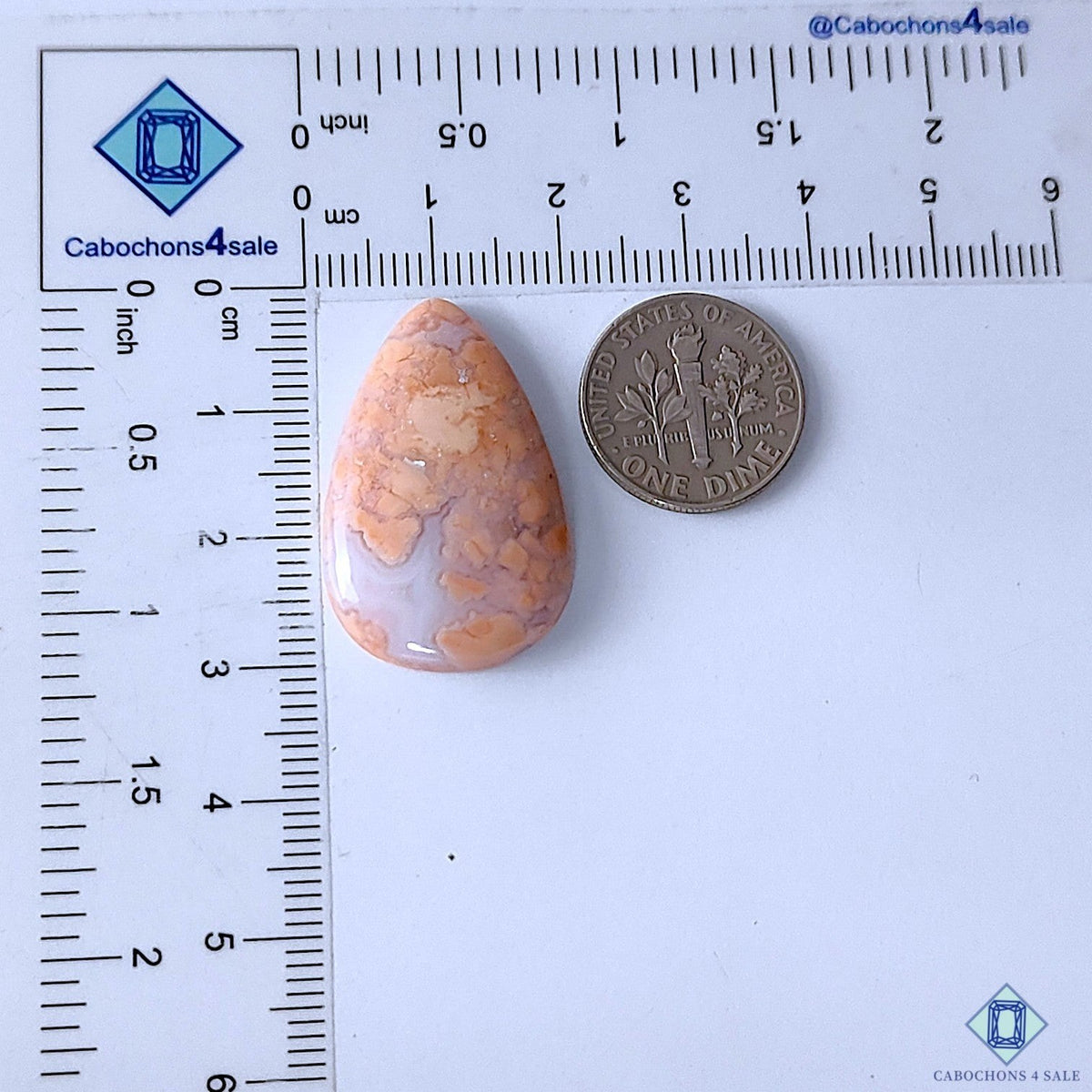 Cabochons4sale orange pear-shaped opaque cotton candy agate cabochon next to a US dime for scale