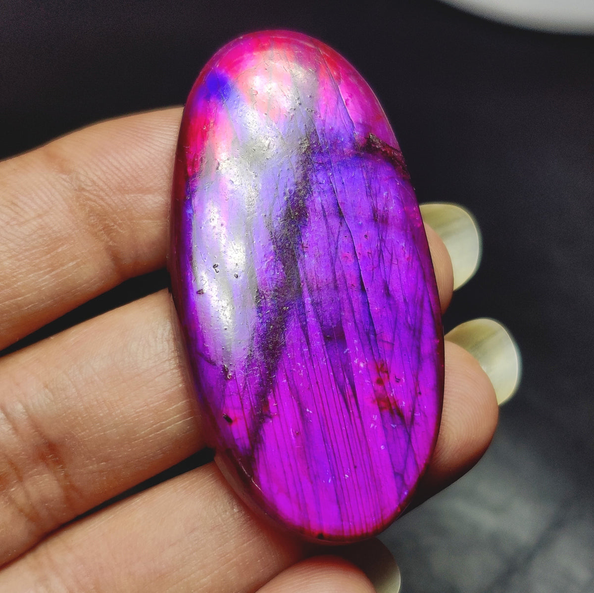 Cabochons4sale oval dyed purple labradorite gemstone cabochon with translucent finish held in hand