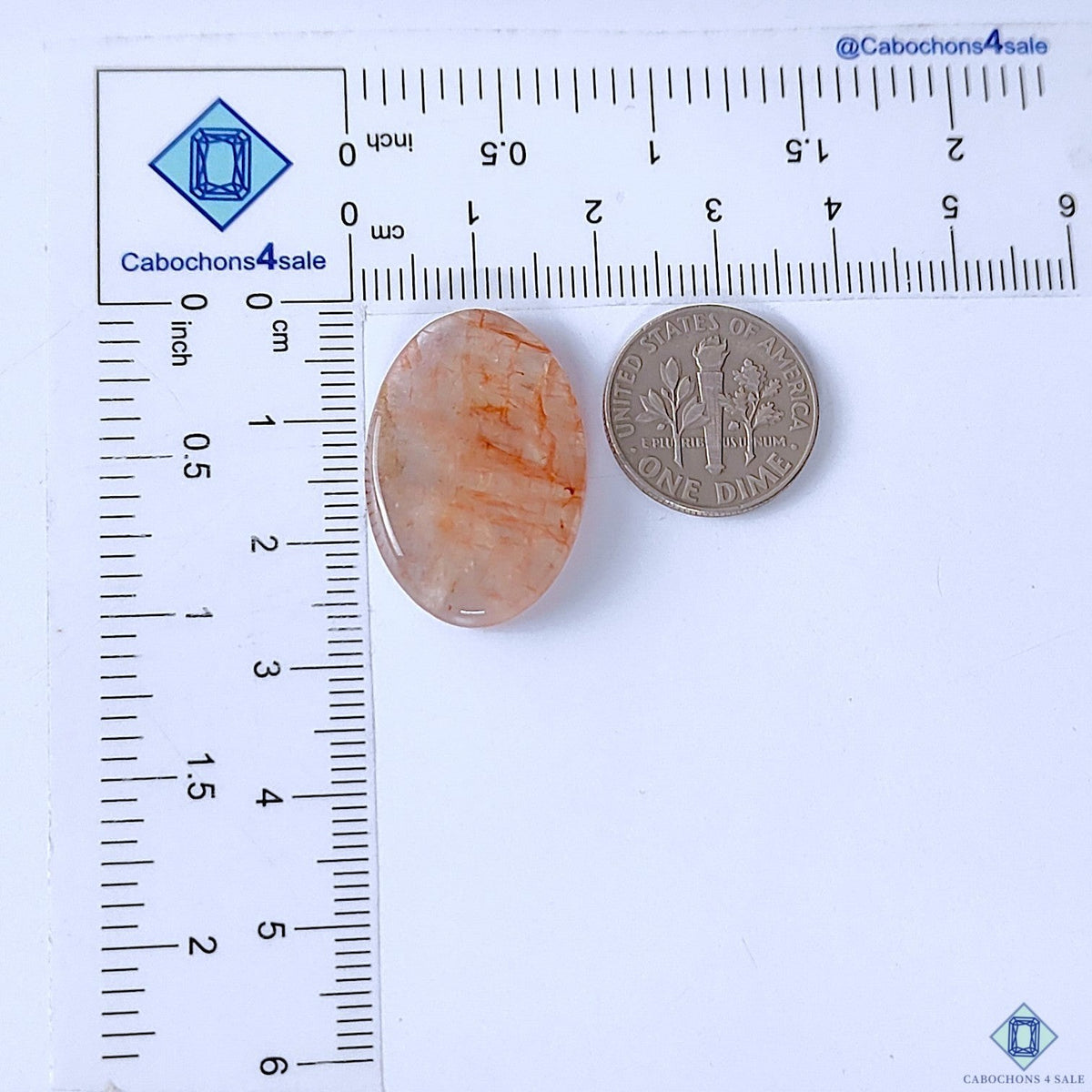 Cabochons4sale oval fire quartz cabochon with red inclusions, translucent finish, 26x18x5mm, shown with a US dime.