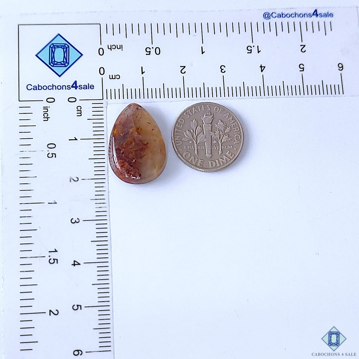 Cabochons4sale pear-shaped translucent fire quartz cabochon with red inclusions next to a US dime for scale