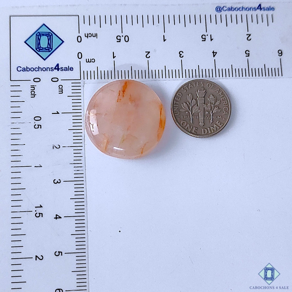 Cabochons4sale round translucent red fire quartz cabochon gemstone measuring 23x7mm next to a US dime for scale