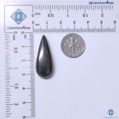 Cabochons4sale grey opaque gun metal pear cabochon gemstone measuring 31x12x6mm next to a US dime for scale