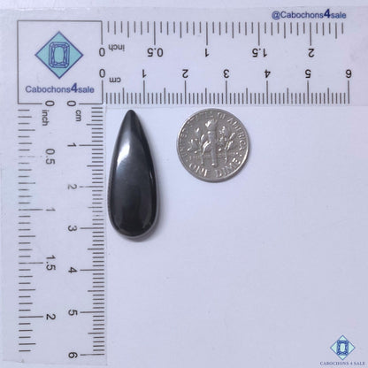 Cabochons4sale grey gun metal pear cabochon gemstone measuring 31x12x5mm with an opaque finish next to a US dime.
