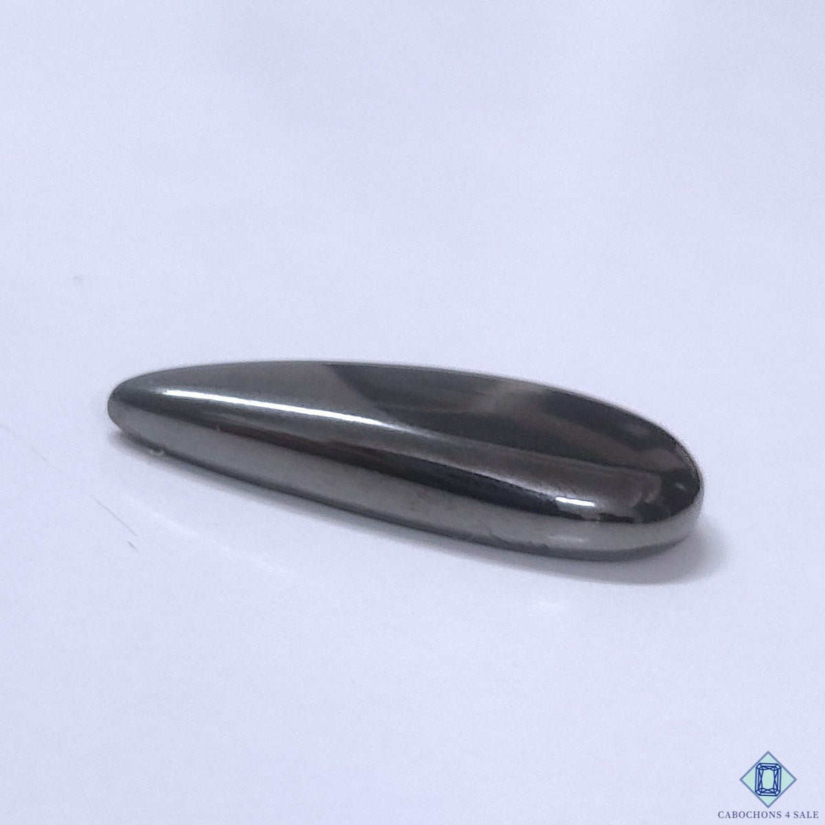 Cabochons4sale grey gun metal pear cabochon gemstone with a smooth opaque finish, 31x12x5mm size.