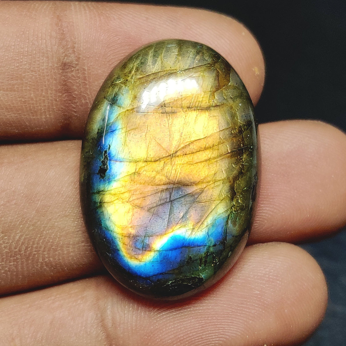 Cabochons4sale oval translucent labradorite gemstone featuring vibrant yellow and blue iridescent flashes