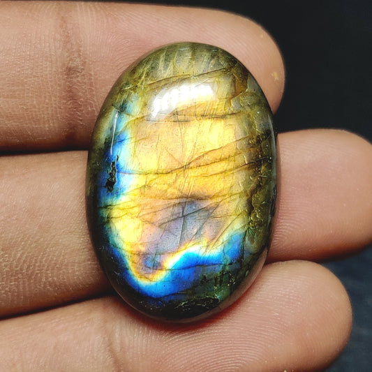 Cabochons4sale oval translucent labradorite gemstone featuring vibrant yellow and blue iridescent flashes