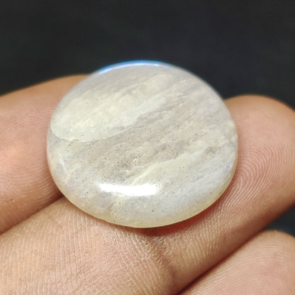 Cabochons4sale natural round translucent white moonstone cabochon gemstone held between fingers