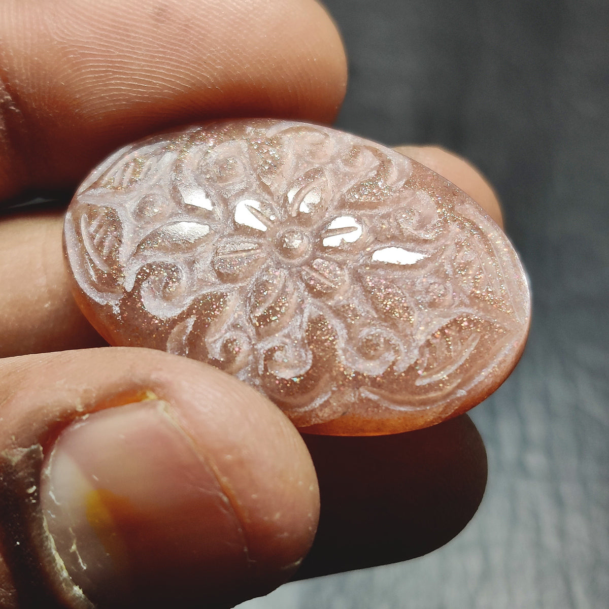 Cabochons4sale oval peach moonstone gemstone with intricate floral carving and translucent brown shimmer