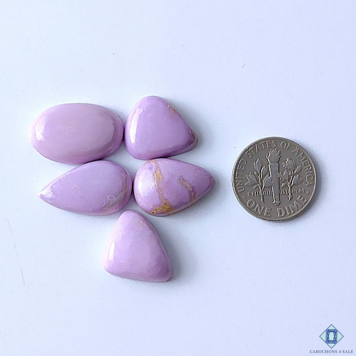 Cabochons4sale purple phosphosiderite gemstone lot in mixed shapes with natural veining next to a US dime for scale