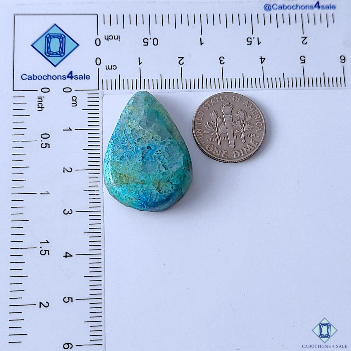 Cabochons4sale pear-shaped opaque Quantum Quattro gemstone in blue and green hues next to a US dime for scale.