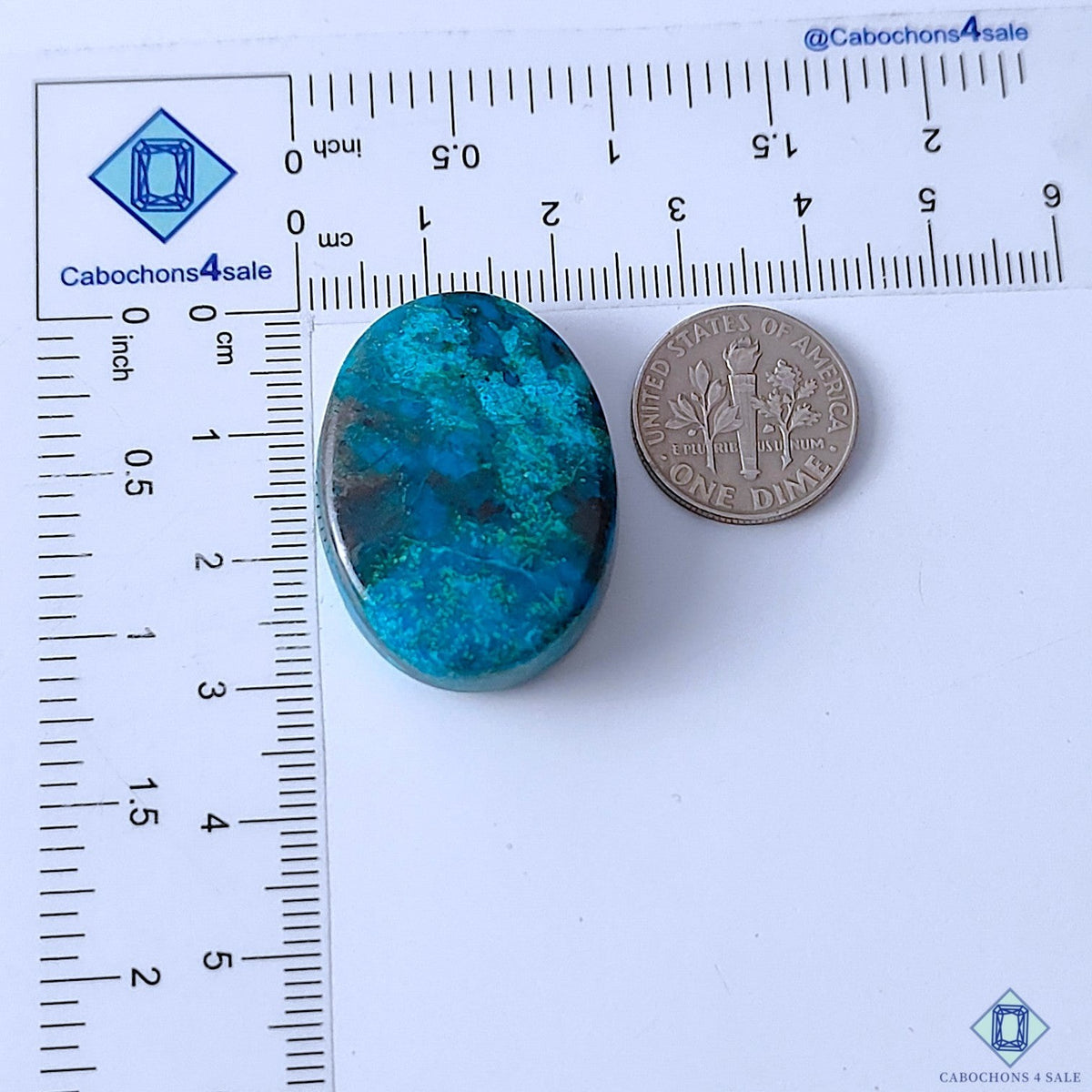 Cabochons4sale oval Quantum Quattro cabochon gemstone in vibrant blue and green with opaque finish next to a US dime.