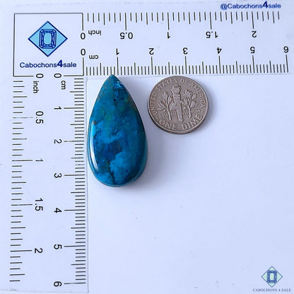 Cabochons4sale pear-shaped Quantum Quattro gemstone cabochon in blue with opaque finish next to a US dime for scale.