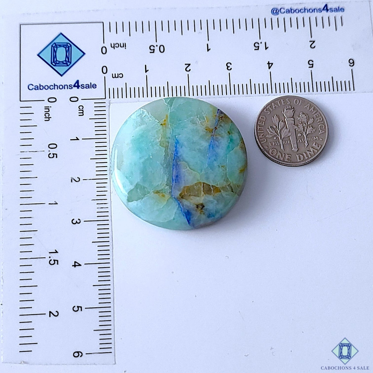 Cabochons4sale round Quantum Quattro gemstone cabochon with blue and green natural patterns next to a US dime