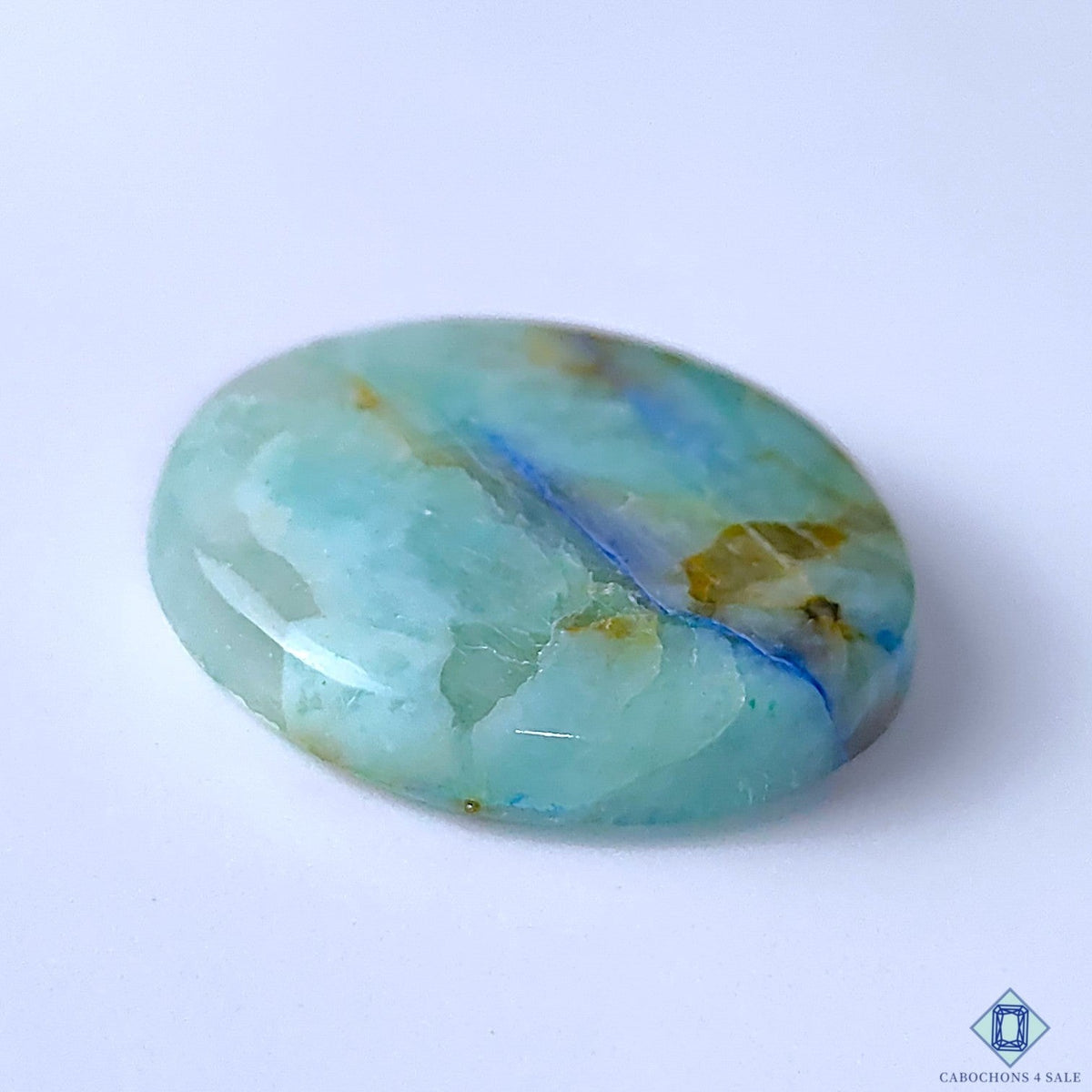 Cabochons4sale round Quantum Quattro cabochon gemstone featuring blue and green opaque patterns, 32x6mm size.
