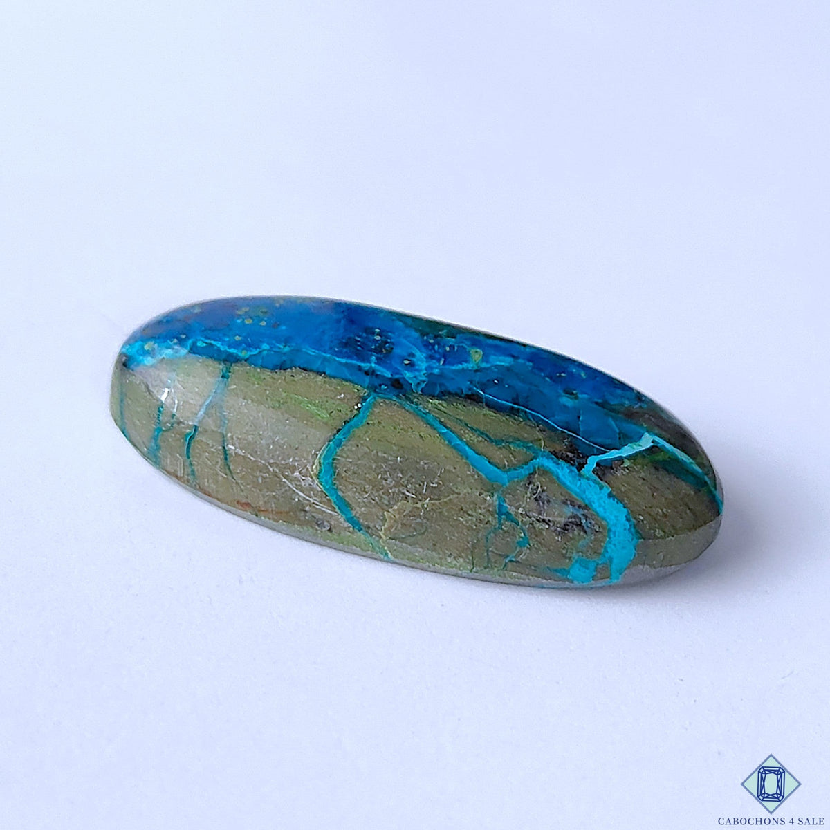 Cabochons4sale oval Quantum Quattro cabochon featuring vibrant blue and earthy green patterns, 33x15x7mm.