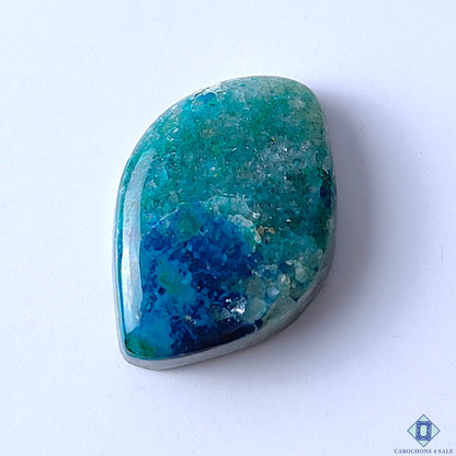 Cabochons4sale fancy Quantum Quattro gemstone cabochon with vibrant blue and green opaque patterns, 31x22x8mm.