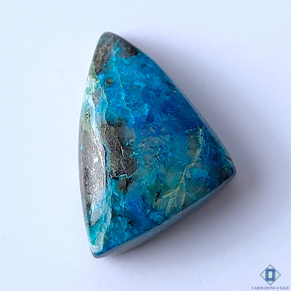 Cabochons4sale natural opaque Quantum Quattro gemstone in a fancy triangular cabochon cut with vibrant blue hues.