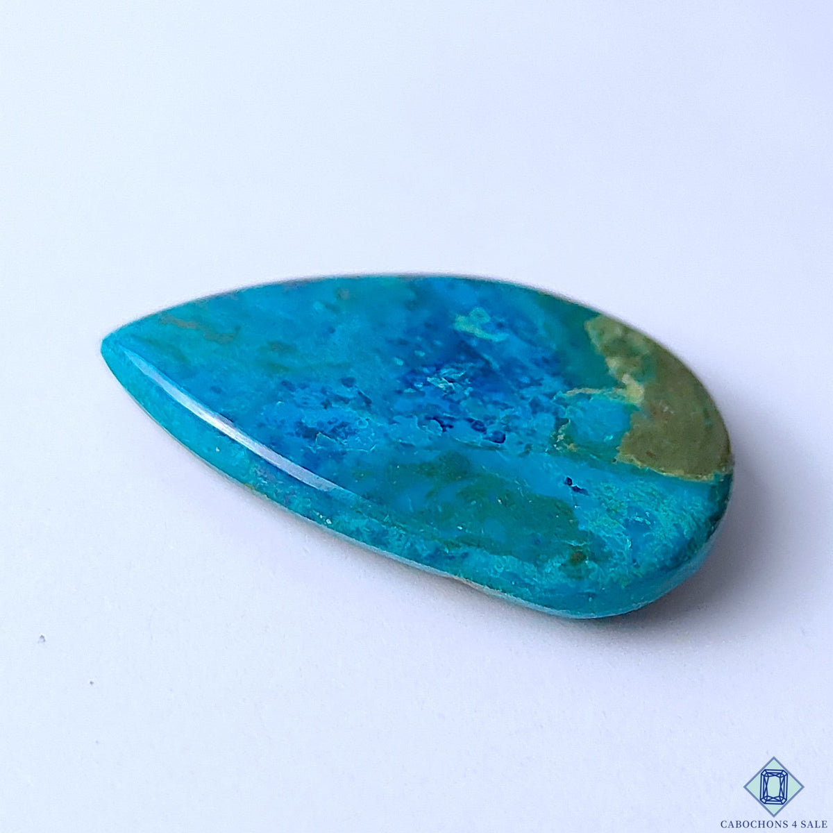 Cabochons4sale pear-shaped Quantum Quattro cabochon featuring vibrant blue and green opaque natural gemstone patterns.