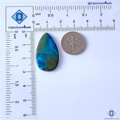 Cabochons4sale pear-shaped Quantum Quattro cabochon gemstone with blue and green patterns next to a US dime for scale.