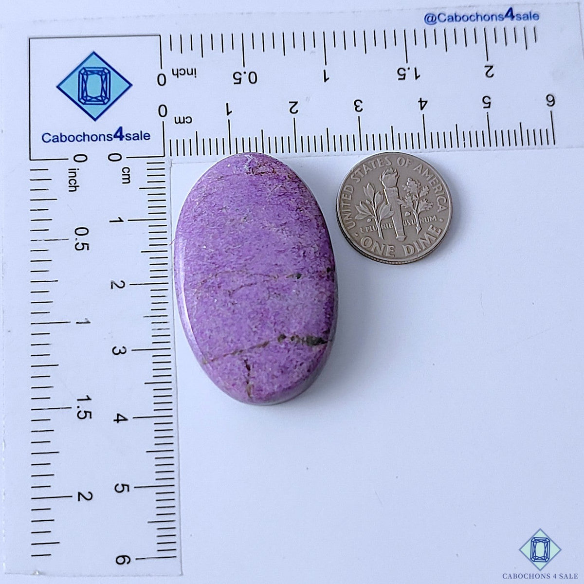 Cabochons4sale oval purple stichtite cabochon gemstone measuring 38x24x7mm shown next to a US dime for scale.