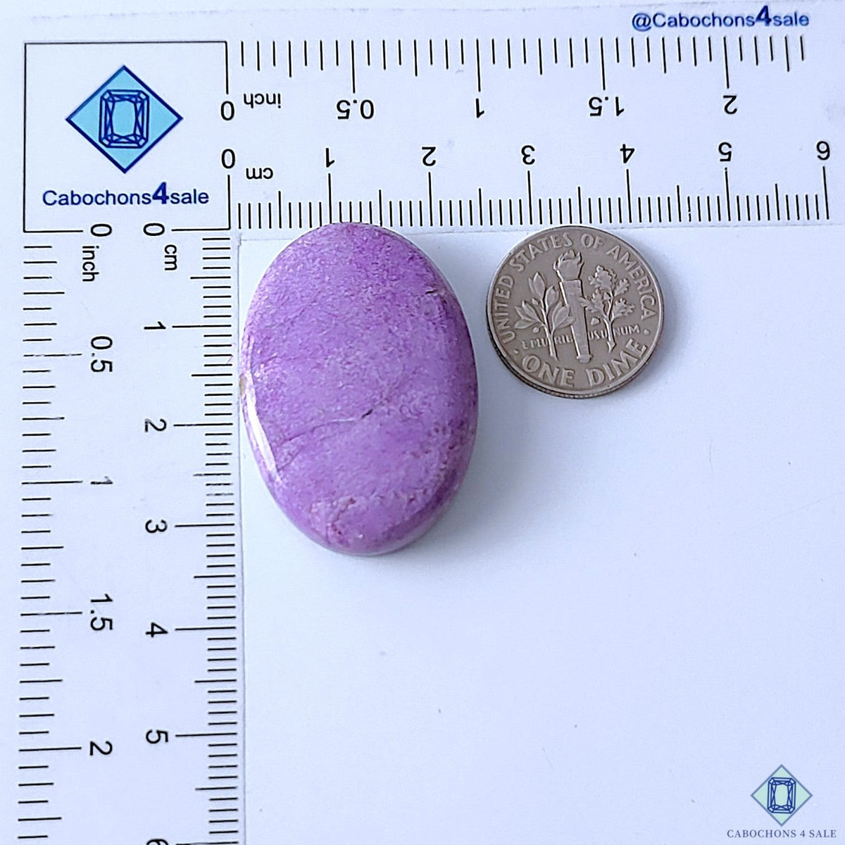 Cabochons4sale purple oval stichtite cabochon gemstone measuring 33x23x7mm next to a US dime for scale