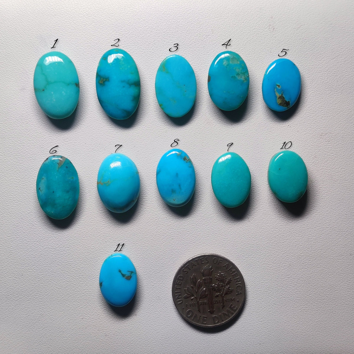 Cabochons4sale collection of eleven oval Arizona turquoise cabochons in blue and green shades with natural matrix.