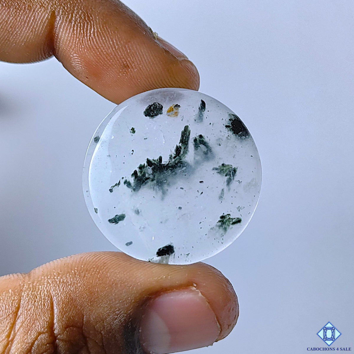 cabochons4sale, black dot quartz round cabochons in white and black tones with distinctive dark dot inclusions, natural mineral details and polished surfaces held between fingers