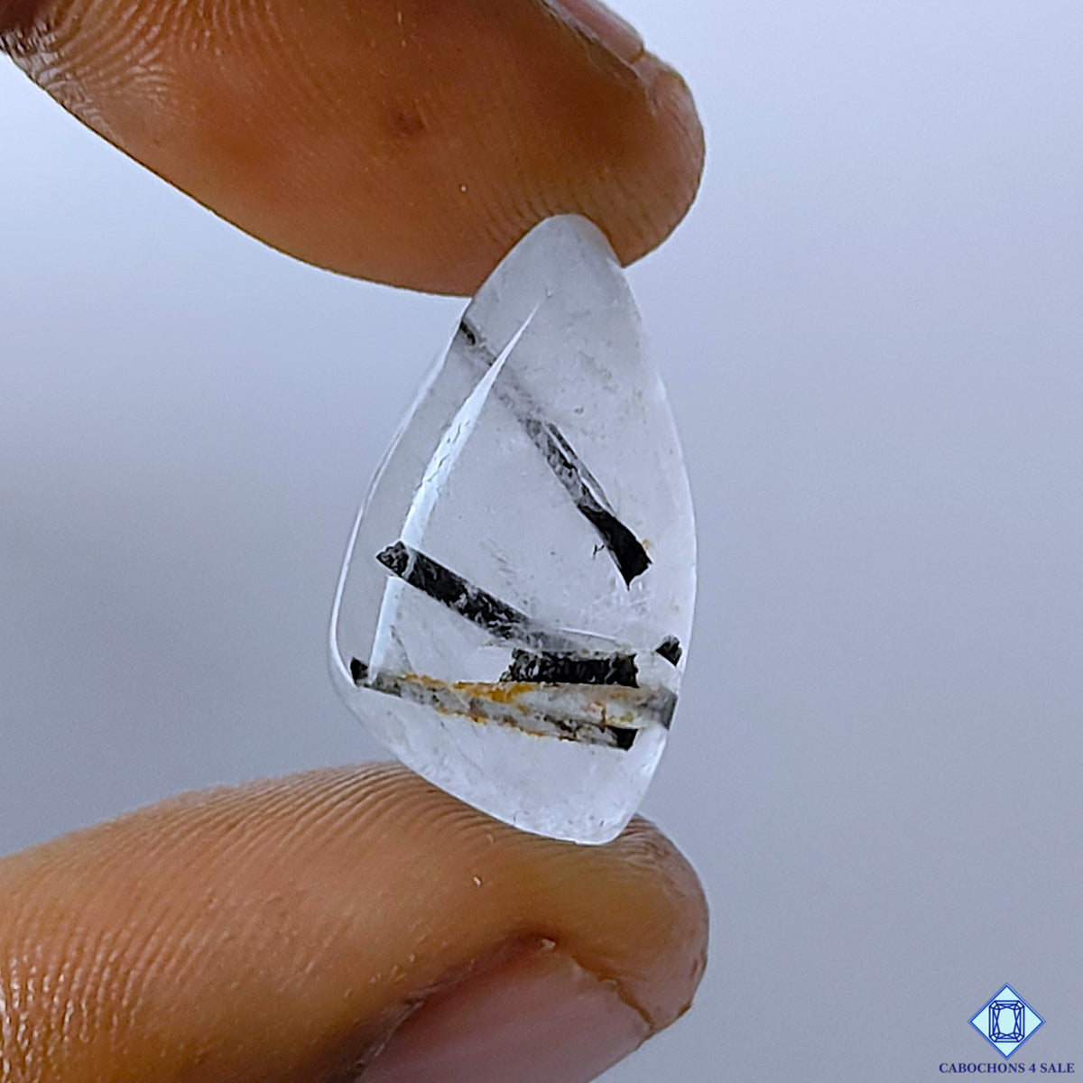 cabochons4sale, black rutile quartz fancy cabochons in black and white tones with fine needle-like rutile inclusions and polished gemstone surfaces held between fingers