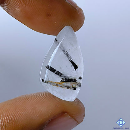 cabochons4sale, black rutile quartz fancy cabochons in black and white tones with fine needle-like rutile inclusions and polished gemstone surfaces held between fingers