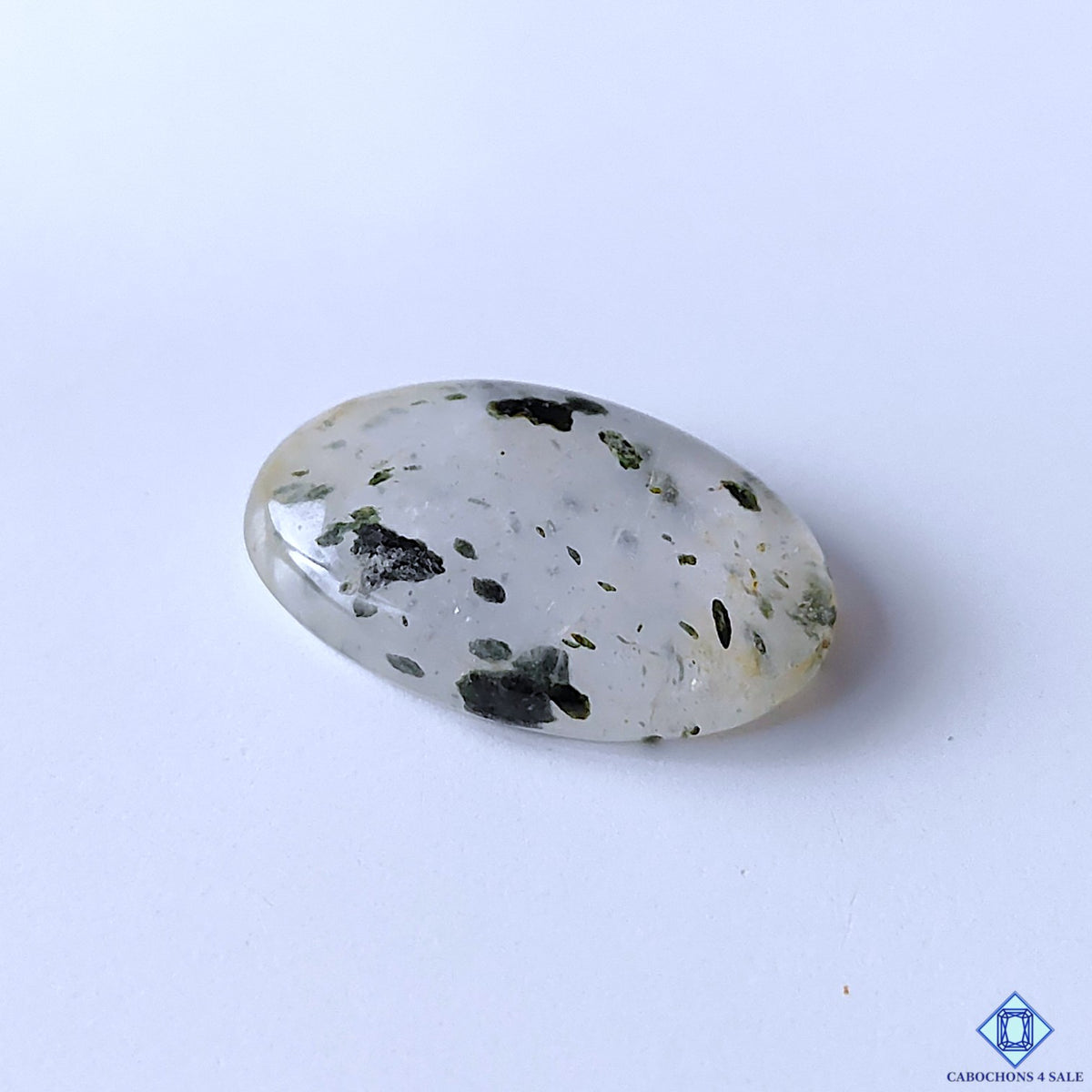 cabochons4sale, polished black dot quartz oval cabochons showcasing contrasting dark inclusions on white quartz, unique dotted formations and organic stone character held between fingers