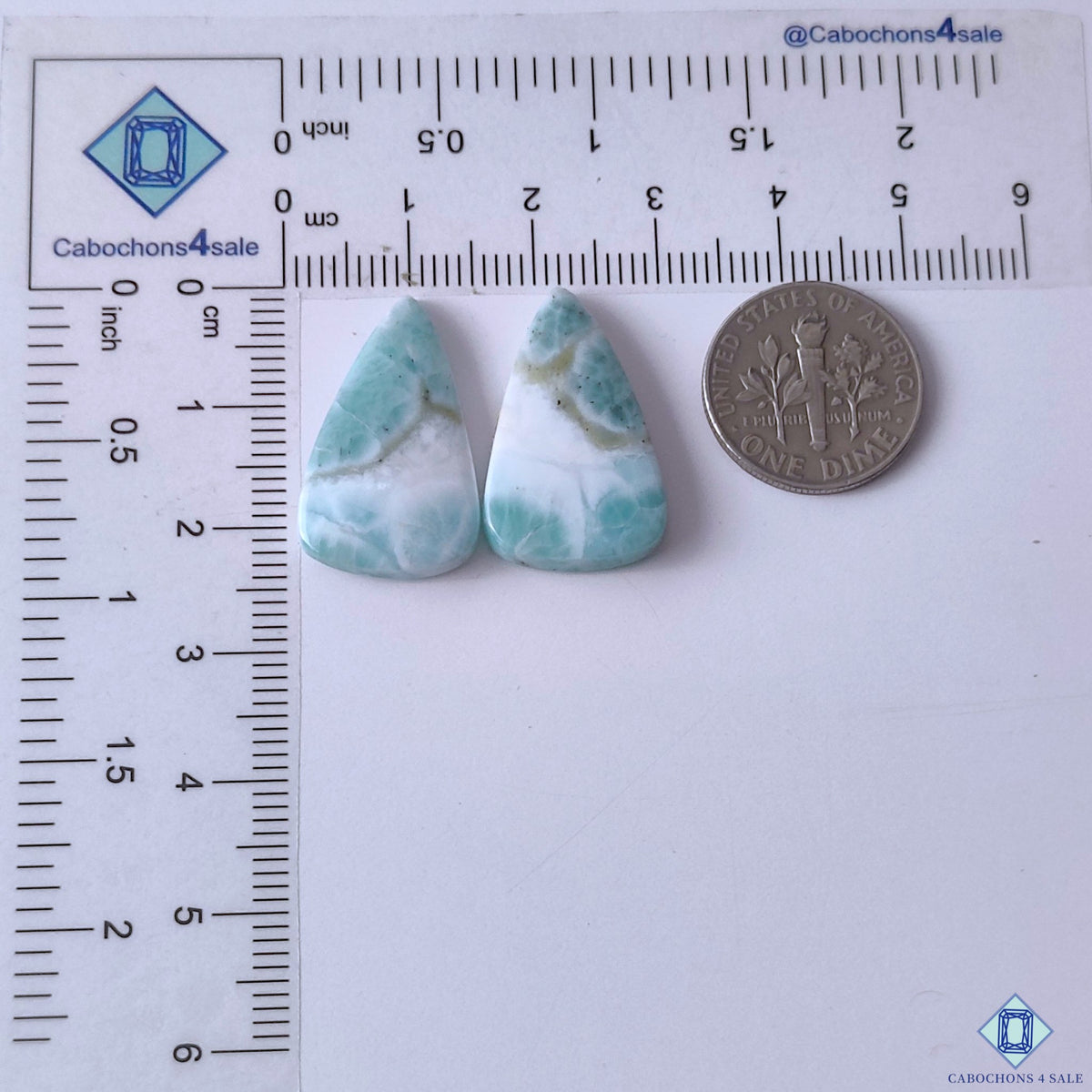 cabochons4sale, aqua blue larimar pear gemstone cabochons accented with creamy white formations, flowing mineral patterns and polished surfaces held between fingers