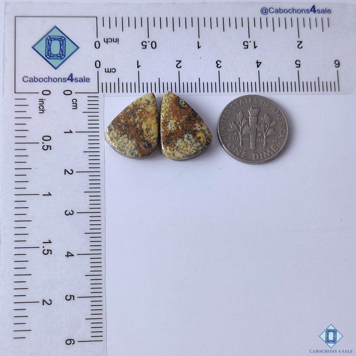 cabochons4sale, brown picture jasper pear shaped gemstone cabochons featuring landscape-like markings and a polished stone surface held between fingers