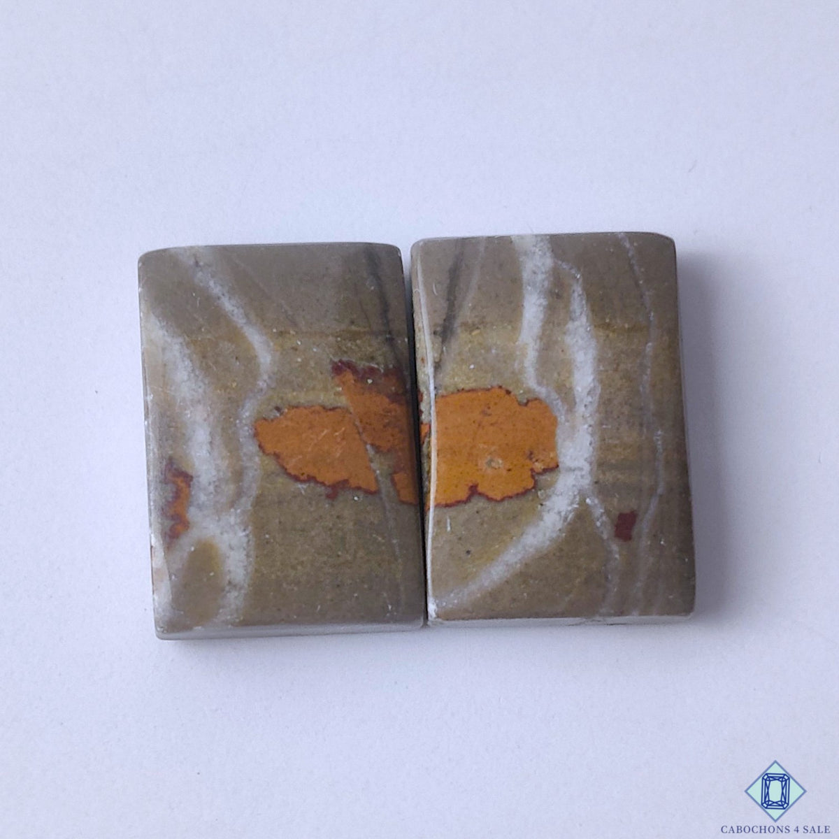 cabochons4sale, natural yellow and brown bumblebee jasper rectangular cabochons with bold banded patterns and polished gemstone surfaces held between fingers