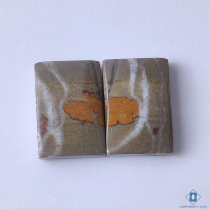 cabochons4sale, natural yellow and brown bumblebee jasper rectangular cabochons with bold banded patterns and polished gemstone surfaces held between fingers