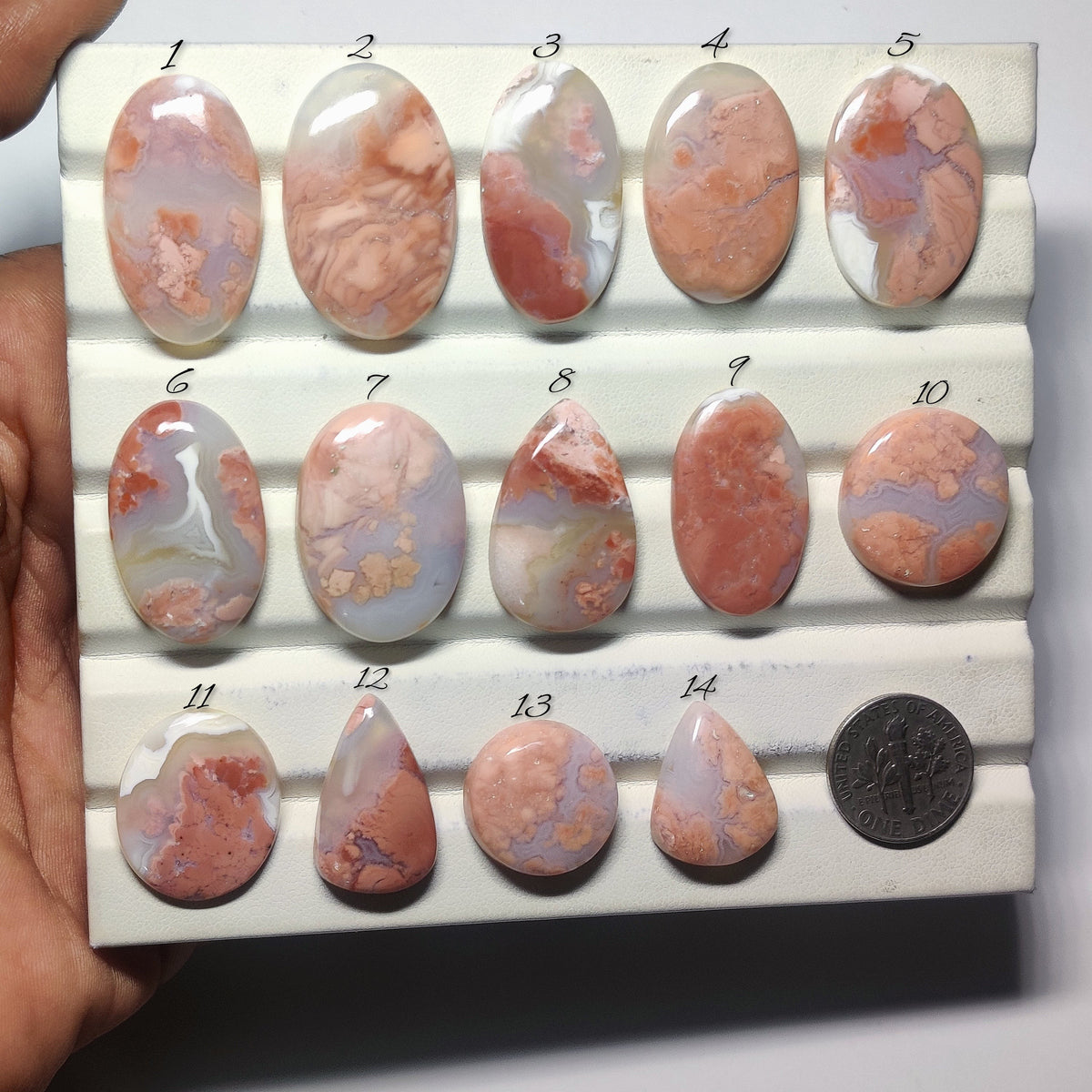 Cabochons4sale collection of polished cherry blossom agate cabochons in various shapes with pink and cream floral patterns