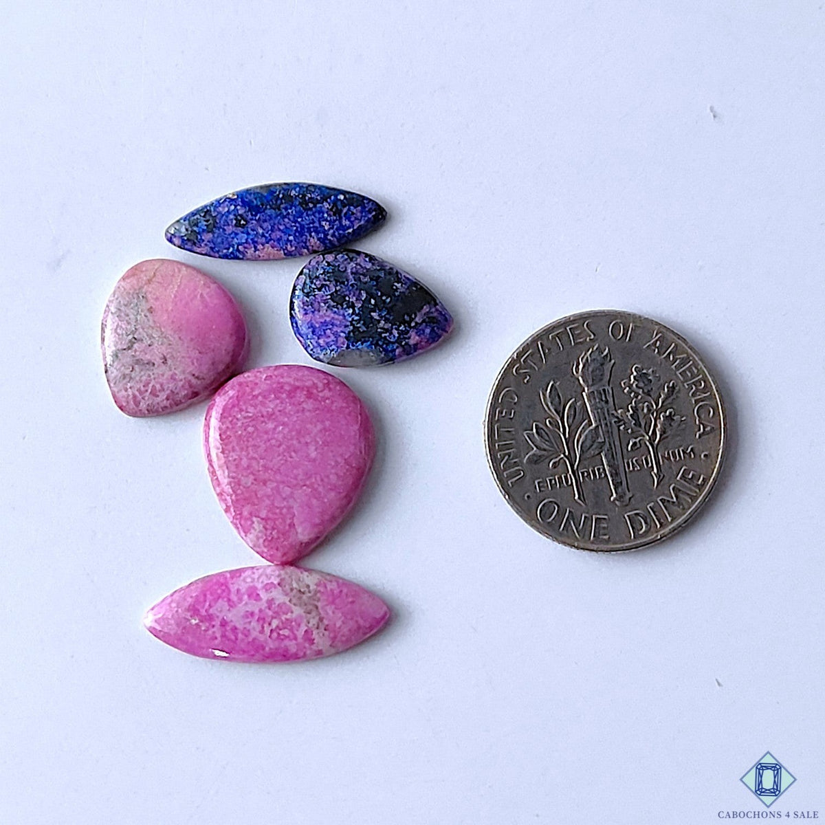 Cabochons4sale mixed shape opaque pink and blue cobalt calcite gemstones next to a US dime for size reference