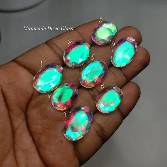 Cabochons4sale manmade disco glass oval stones with vibrant iridescent sparkle held in a hand for jewelry making